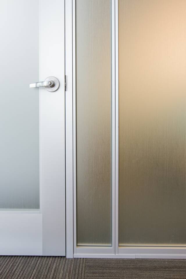 Aluminum & glass door with lever lockset.