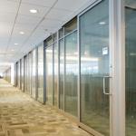 Office front walls with narrow-stile aluminum sliding doors mounted on the exterior.