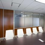 The attractive and functional panels for this conference room feature wood veneer inserts and opaque glazing to provide privacy.