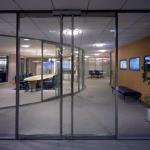 Pivoting glass doors are used with full-height glazed panels.