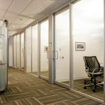 Narrow-stile aluminum sliding doors are installed on the office interior.  The 10" offset tube pull is a standard option.