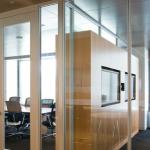 Millwork cabinetry and custom glazing are used together in the beautiful design of a wall between conference rooms.