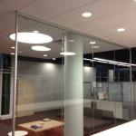 a freestanding glass wall with glass jambs at the ends