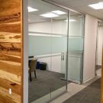 Slimline office front elevation with a frameless pivot door with optional locking bottom door rail.